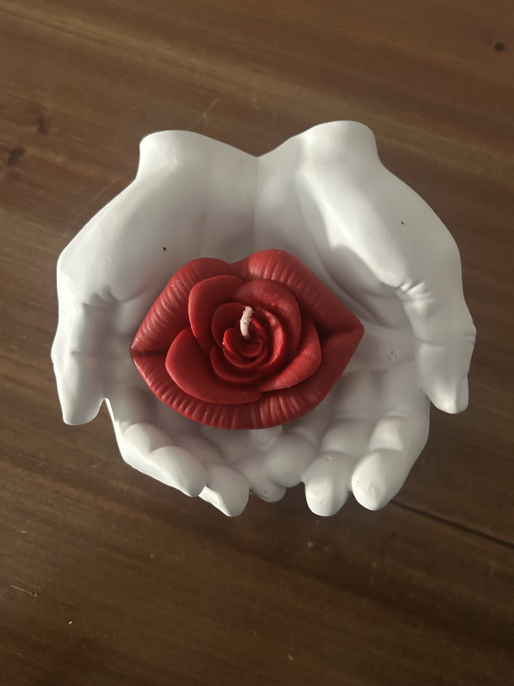 main qui tient bouche en rose